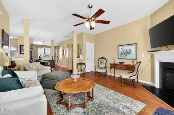 a living room with furniture a fireplace and a flat screen tv