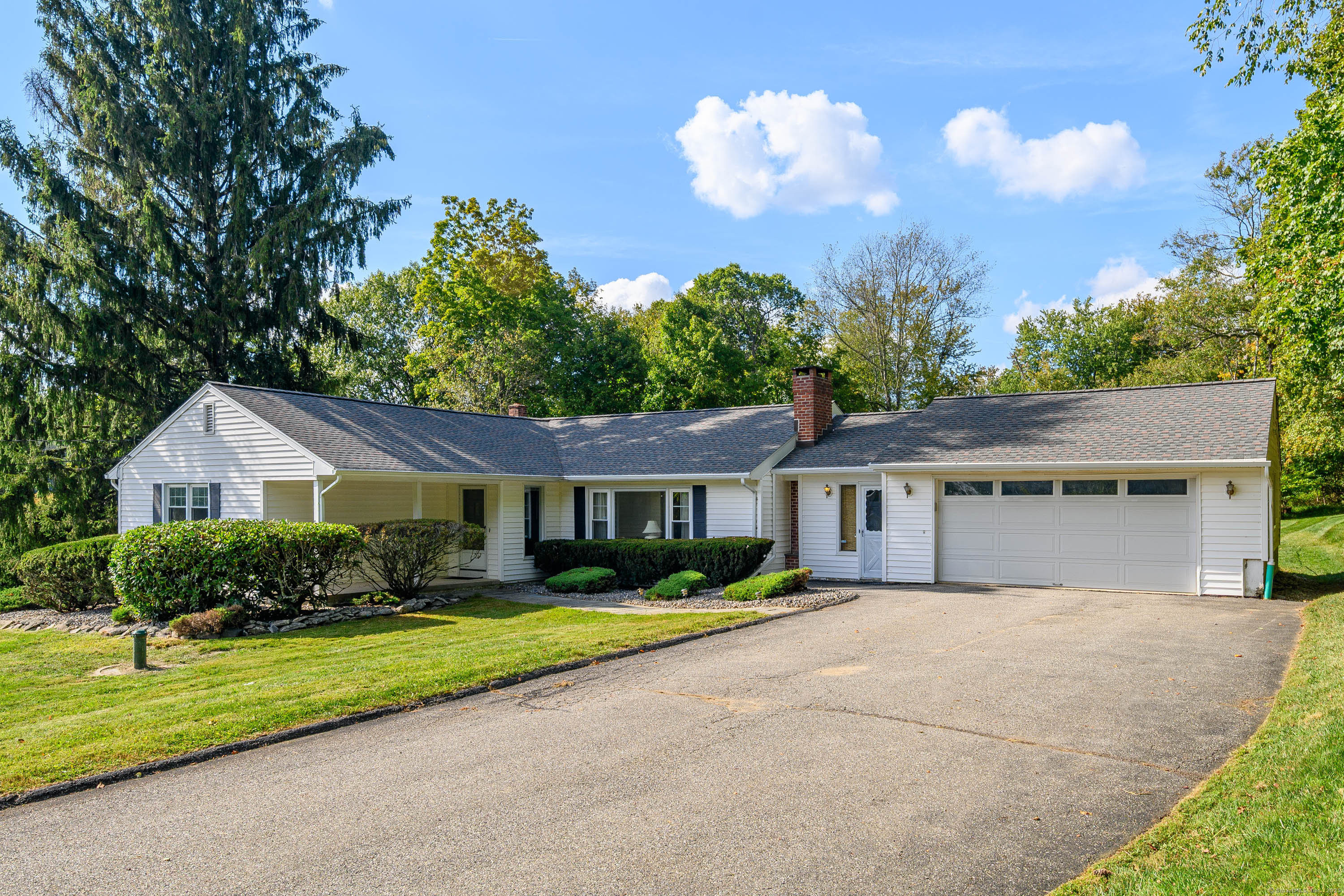 a front view of house with yard and green space