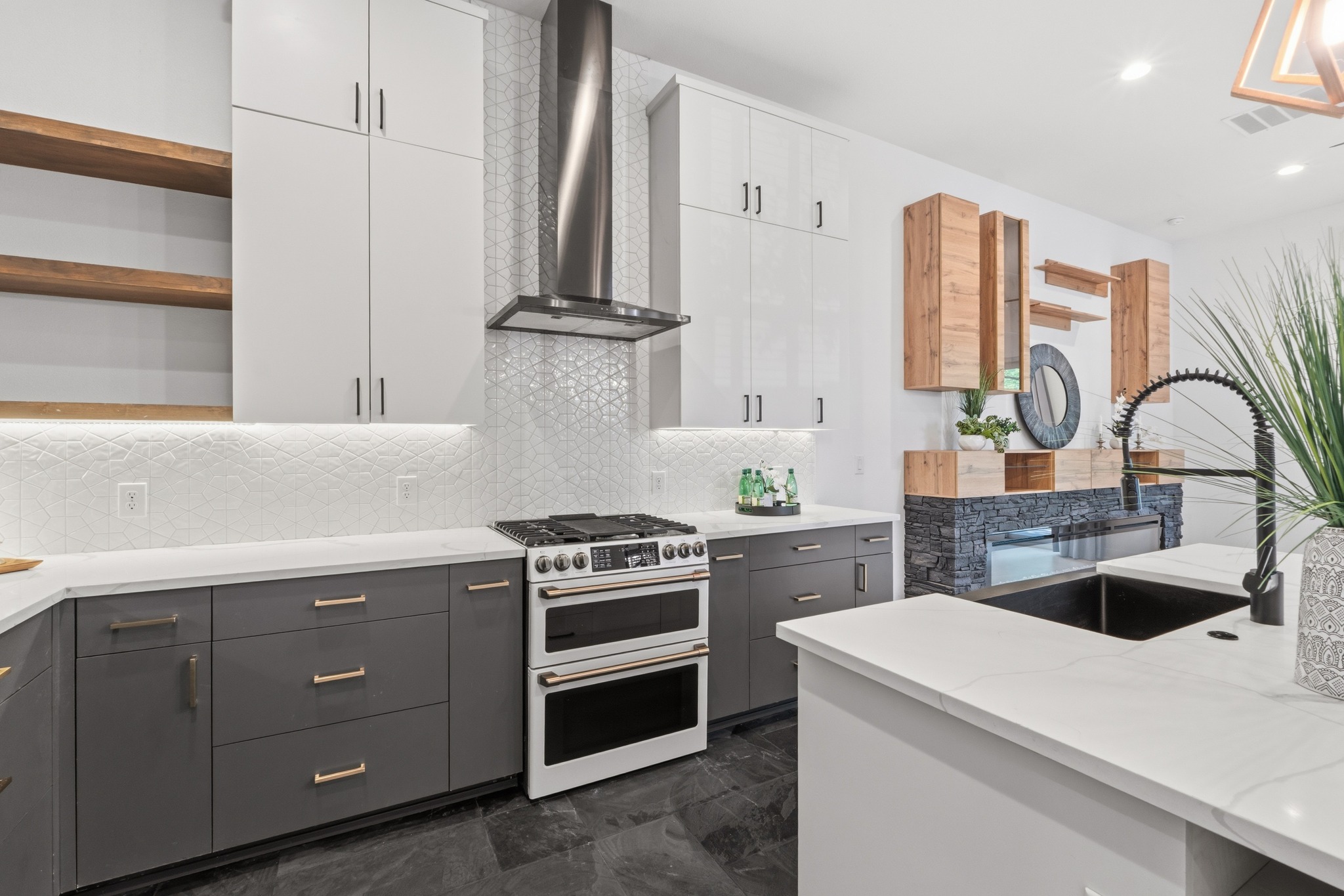 3304 East 17th Street, Unit B Austin, TX 78721 - Photo 35 of 35 A well-equipped kitchen features a gas range, a modern range hood, and a convenient kitchen island for meal preparation. Wonderful open concept floor plan.