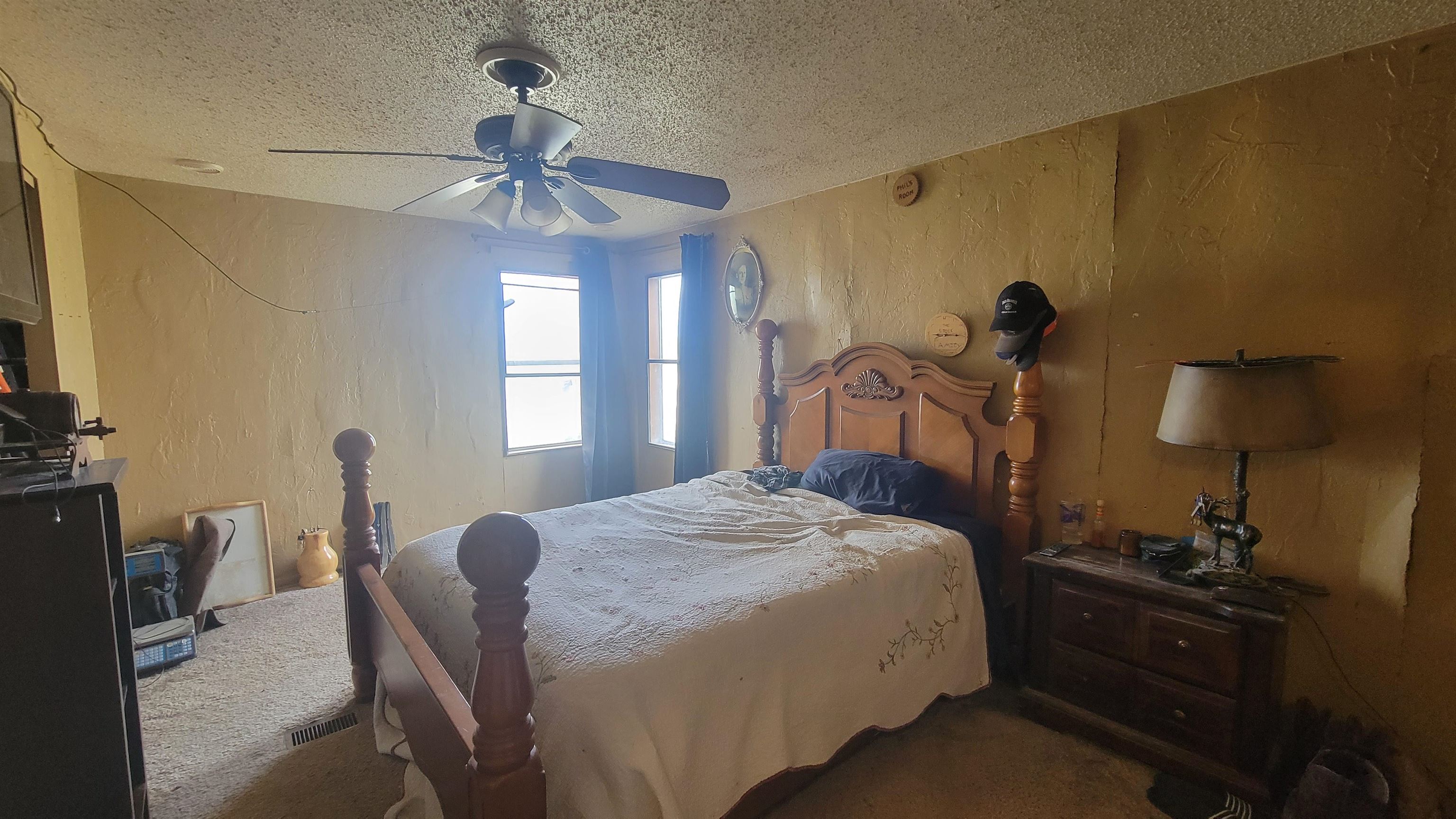 1844 M Road Fruita, CO 81521 - Photo 23 of 32 a bedroom with a bed and a chandelier