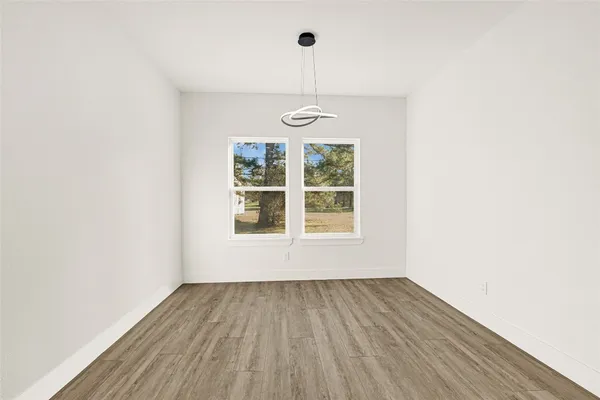 a bedroom with a large bed couch and a window