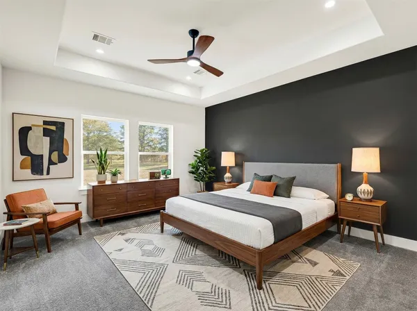 an empty room with a ceiling fan and wooden floor