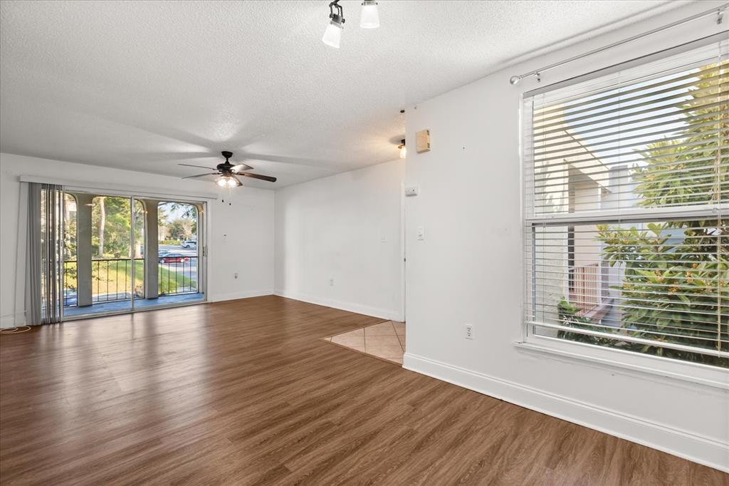 512 Orange Drive, Unit 32 Altamonte Springs, FL 32701 - Photo 12 of 16 a view of an empty room with a window and wooden floor