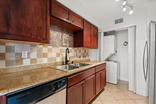 a kitchen with a sink and a refrigerator