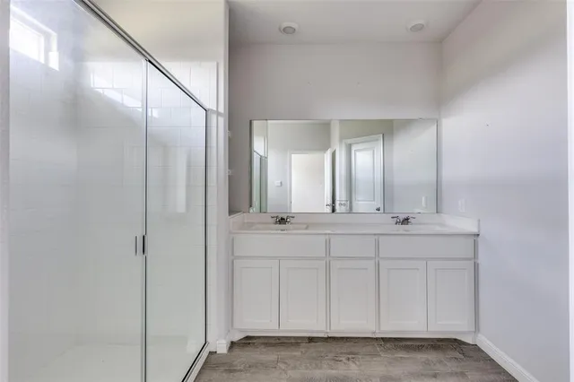 a bathroom with a double vanity sink and mirror