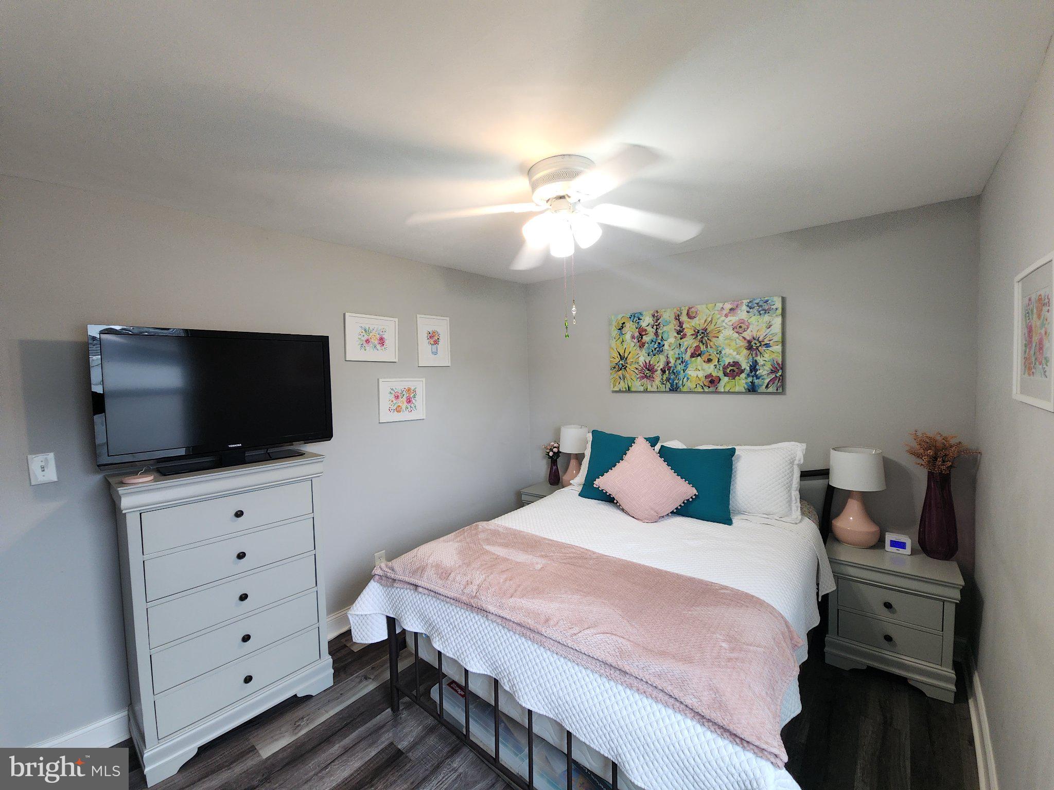 802 Devon Road Riverside, NJ 08075 - Photo 12 of 29 a bedroom with a bed and a flat screen tv