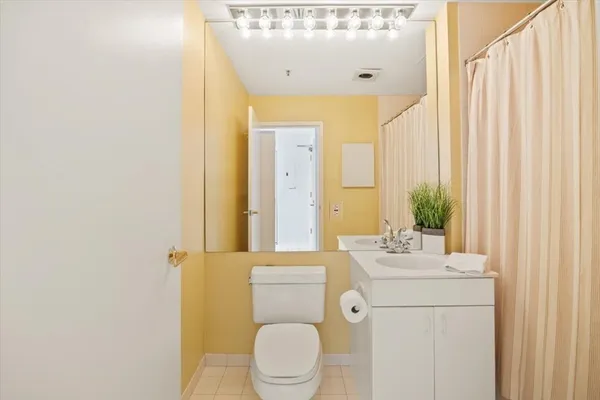 a bathroom with a sink mirror vanity and toilet