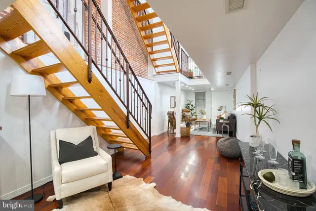 a living room with furniture and a dining table