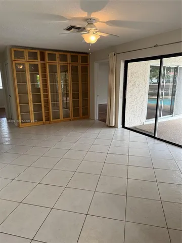 a view of a livingroom with an empty space and a window