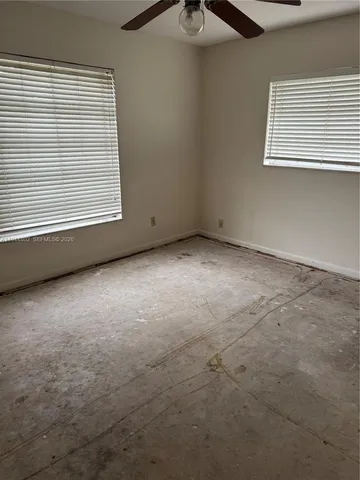 a bathroom with a granite countertop toilet sink and mirror