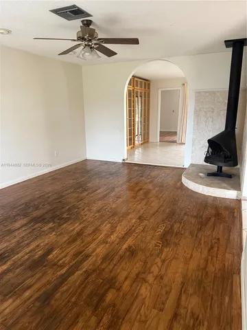 a kitchen with a sink a refrigerator and a stove top oven
