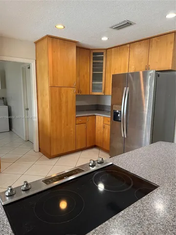 a kitchen with a sink a counter top space and stainless steel appliances