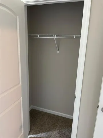 an empty room with wooden floor and cabinet