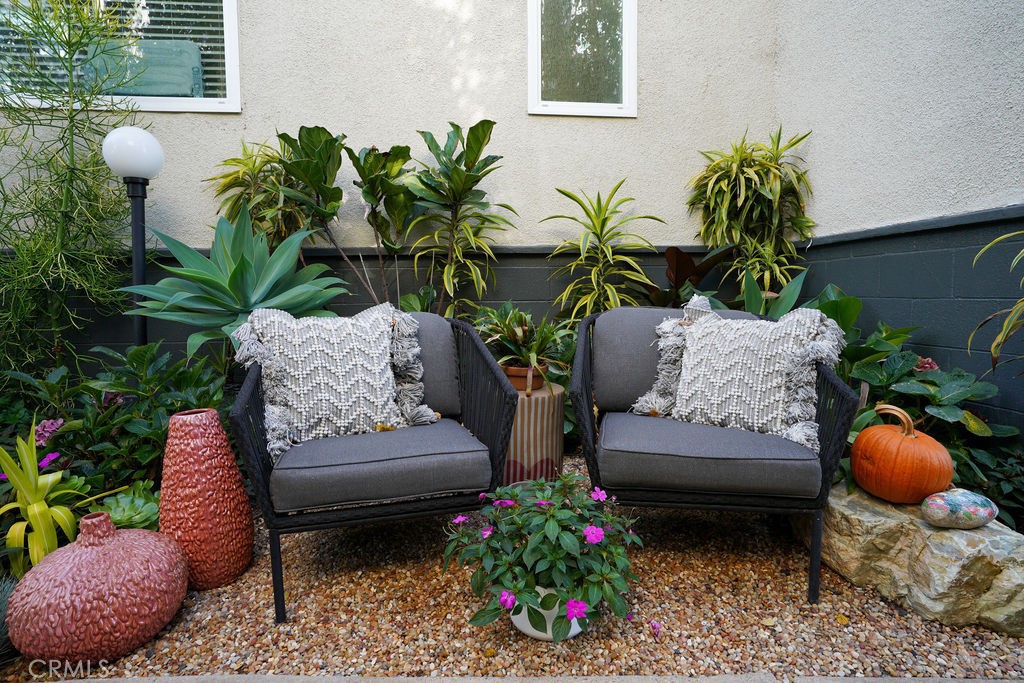 320 12th Street, Unit 5 Seal Beach, CA 90740 - Photo 5 of 18 a living room filled with furniture and flowers