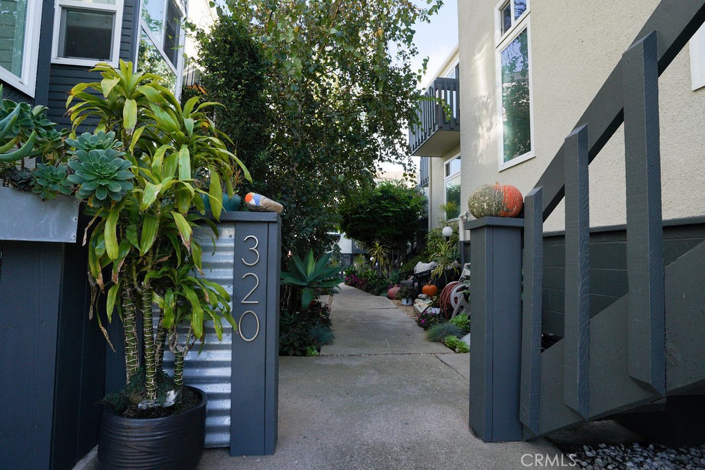 320 12th Street, Unit 5 Seal Beach, CA 90740 - Photo 6 of 18 a house with potted plants in front of door