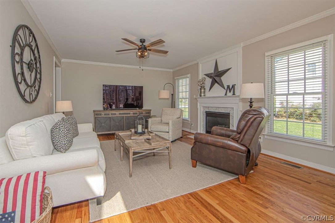 2011 Corner Rock Road Midlothian, VA 23113 - Photo 11 of 34 a living room with furniture a ceiling fan a fireplace and a window
