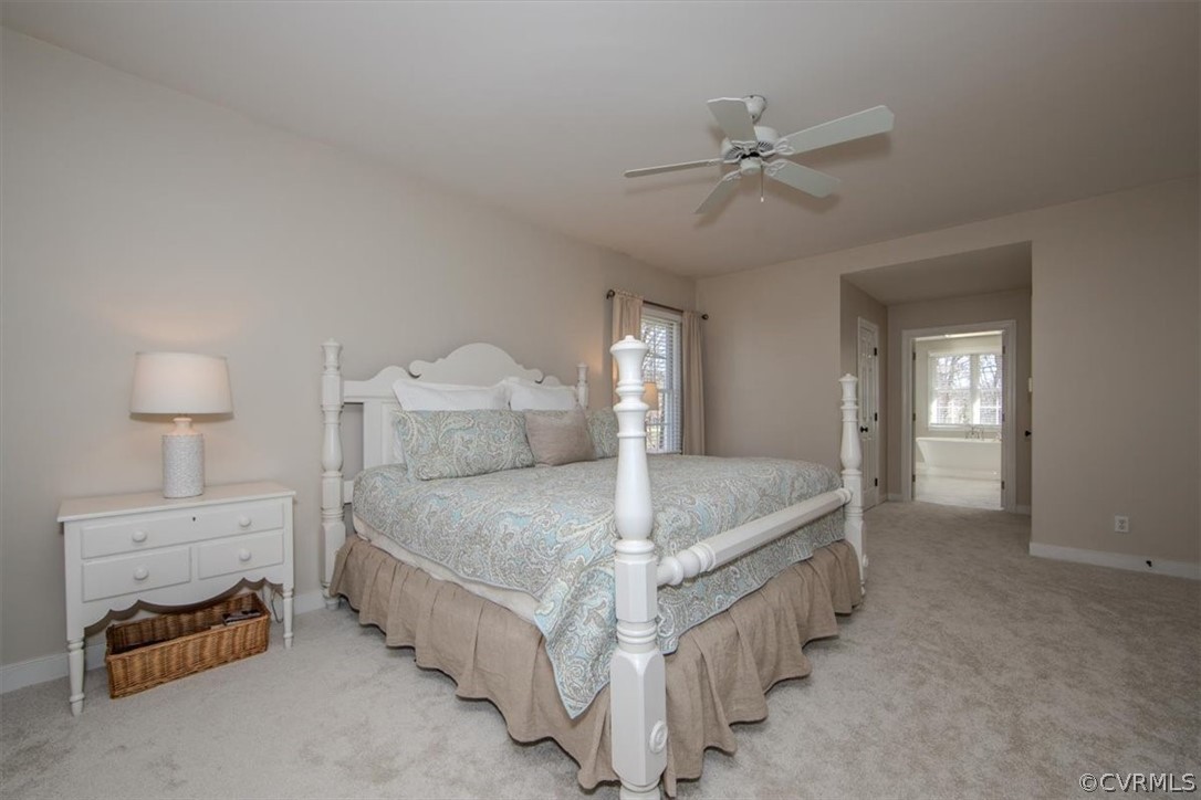 2011 Corner Rock Road Midlothian, VA 23113 - Photo 16 of 34 a spacious bedroom with a bed and a chandelier