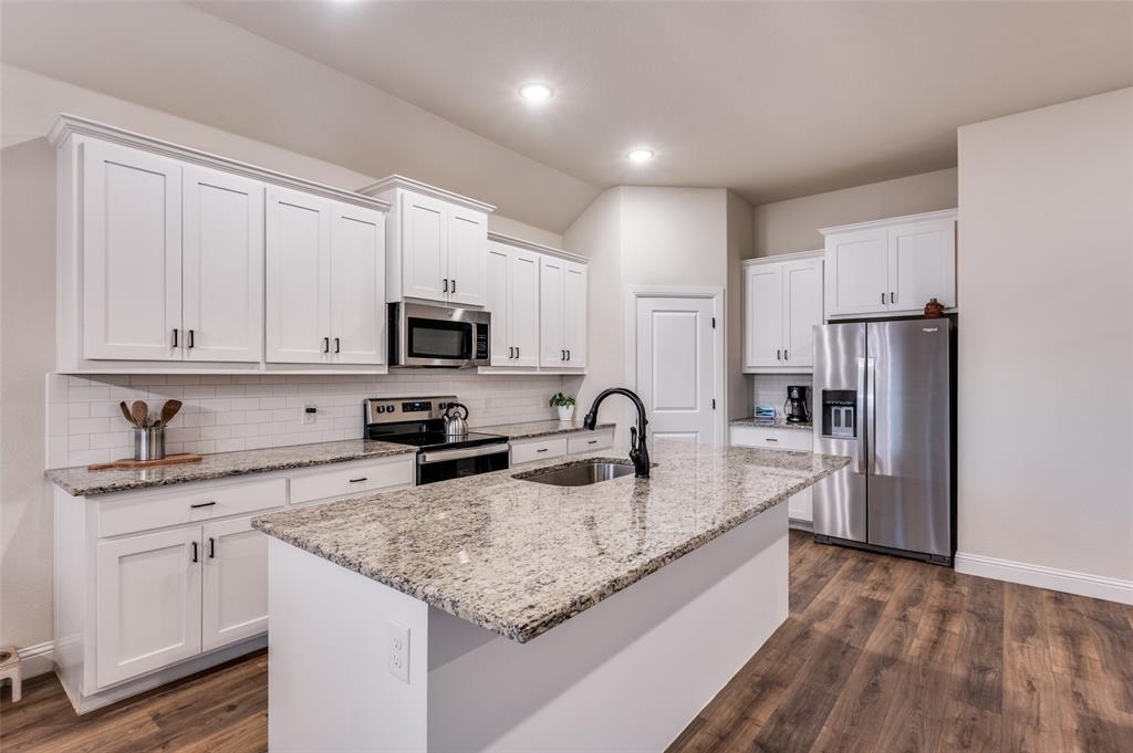 331 Osage Court Krum, TX 76249 - Photo 10 of 19 Shaker cabinets, bright! Walk-in pantry
