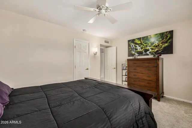 a bedroom with a bed and a flat tv screen