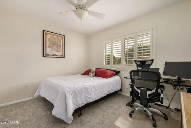 a bedroom with a bed and a desk