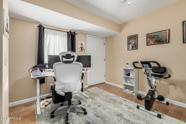 a view of a workspace with furniture and windows