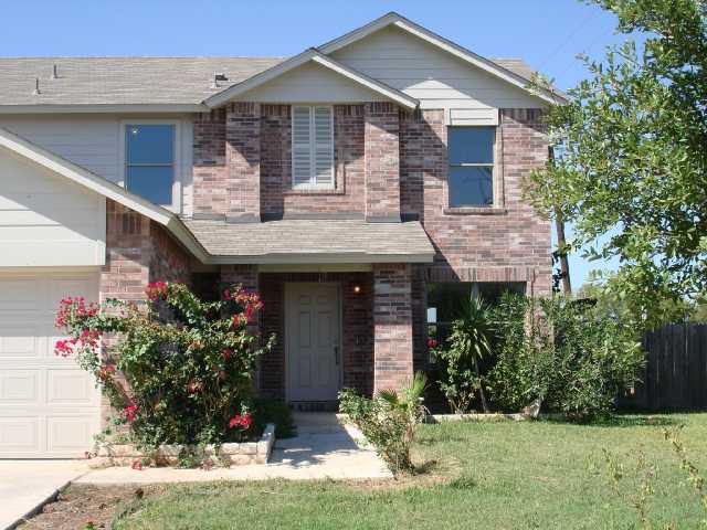 155 Vicksburg Loop Elgin, TX 78621 - Photo 1 of 1 a front view of a house with garden