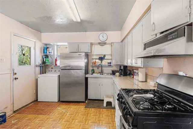 a kitchen with stainless steel appliances granite countertop a stove and a refrigerator