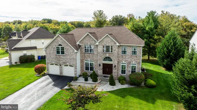 a aerial view of a house with yard and green space