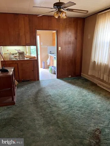 an empty room with a fireplace and painted walls