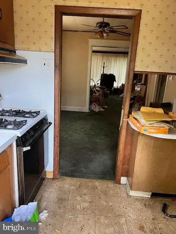 a view of living room with furniture and a fireplace