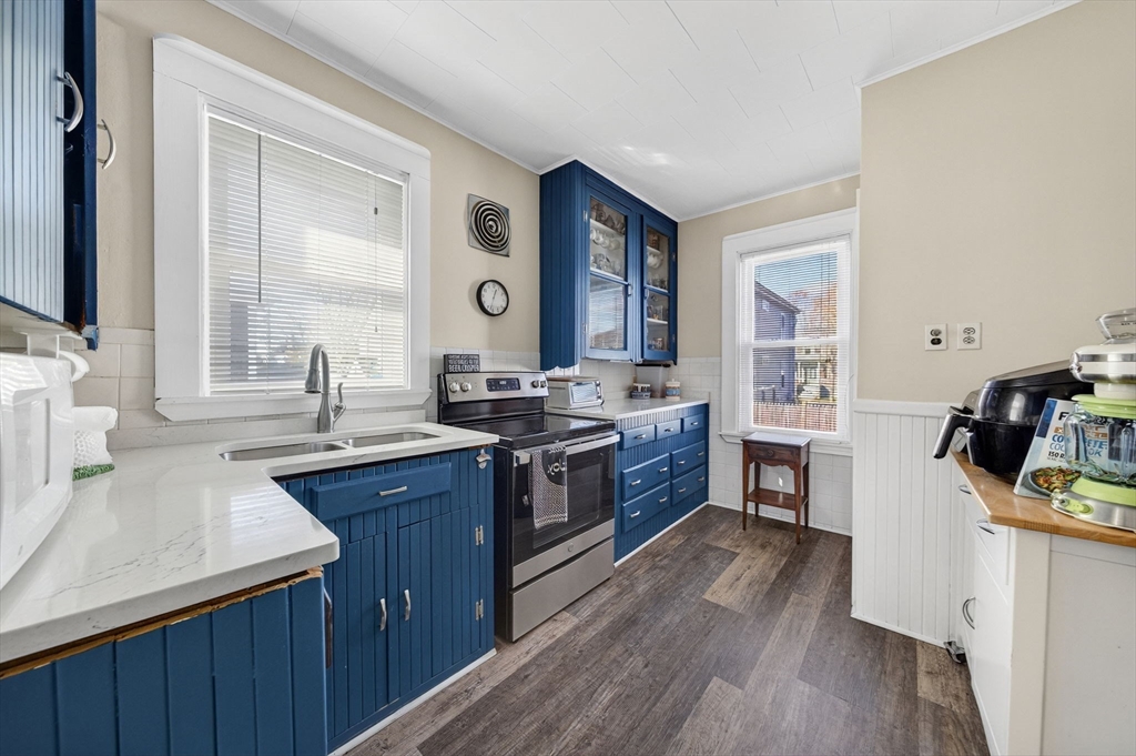 18 Maple Street Fairhaven, MA 02719 - Photo 13 of 39 a kitchen with stainless steel appliances granite countertop a sink stove and wooden floor