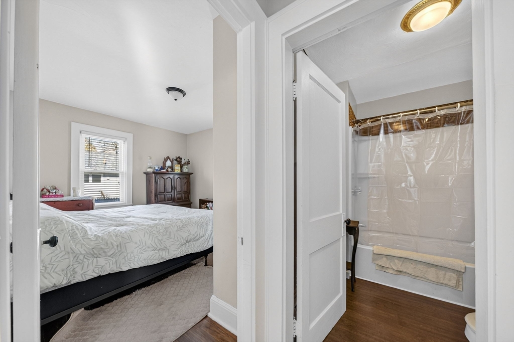 18 Maple Street Fairhaven, MA 02719 - Photo 17 of 39 a bedroom with a bed and a mirror