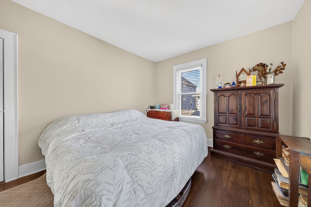 18 Maple Street Fairhaven, MA 02719 - Photo 18 of 39 a bedroom with a bed and wooden floor