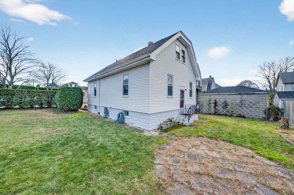 18 Maple Street Fairhaven, MA 02719 - Photo 32 of 39 a view of a house with a yard and potted plants