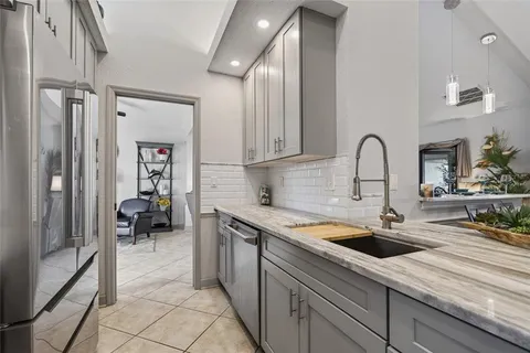 a kitchen with stainless steel appliances granite countertop a stove and a refrigerator
