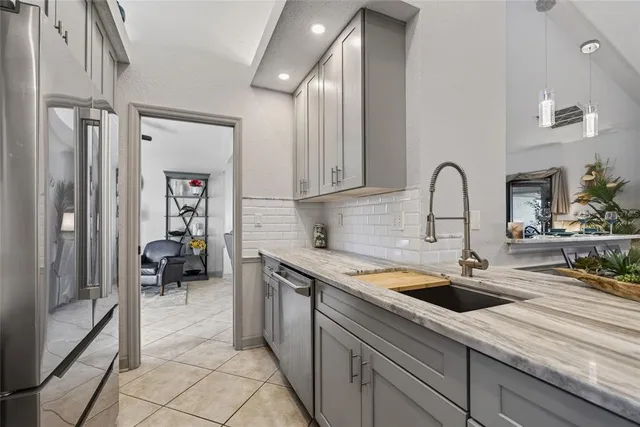 a kitchen with stainless steel appliances granite countertop a stove and a refrigerator