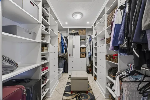 a spacious bedroom with a bed and a cabinets