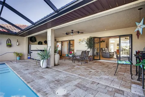 a view of a patio with a table and chairs and potted plants