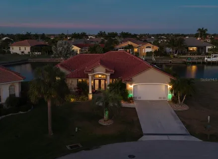 a view of hallway with furniture and a chandelier