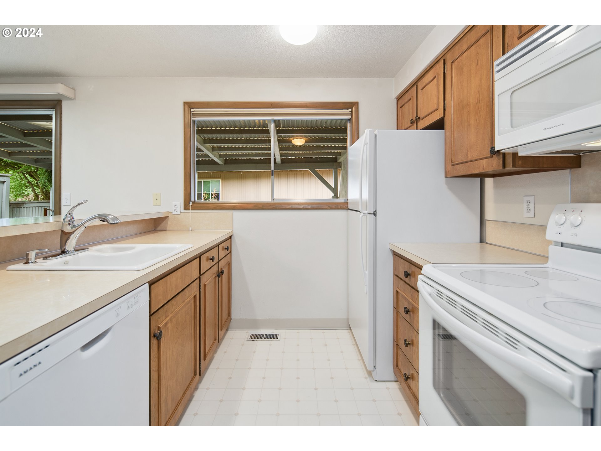 1065 Chestnut Street Northwest Salem, OR 97304 - Photo 18 of 44 a kitchen with a sink stove and cabinets