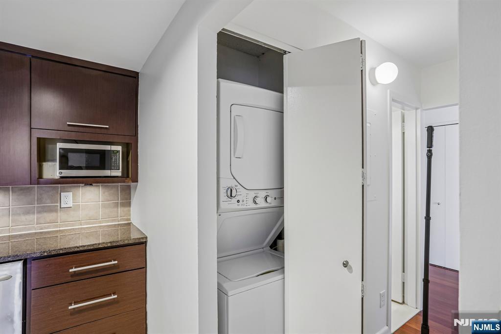 1077 River Road, Unit 1013 Edgewater, NJ 07020 - Photo 12 of 24 a kitchen with a refrigerator and cabinets