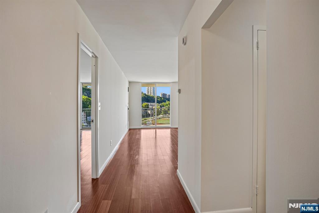 1077 River Road, Unit 1013 Edgewater, NJ 07020 - Photo 7 of 24 a view of a hallway with wooden floor