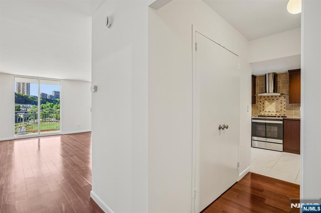 1077 River Road, Unit 1013 Edgewater, NJ 07020 - Photo 8 of 24 a view of a kitchen from the hallway