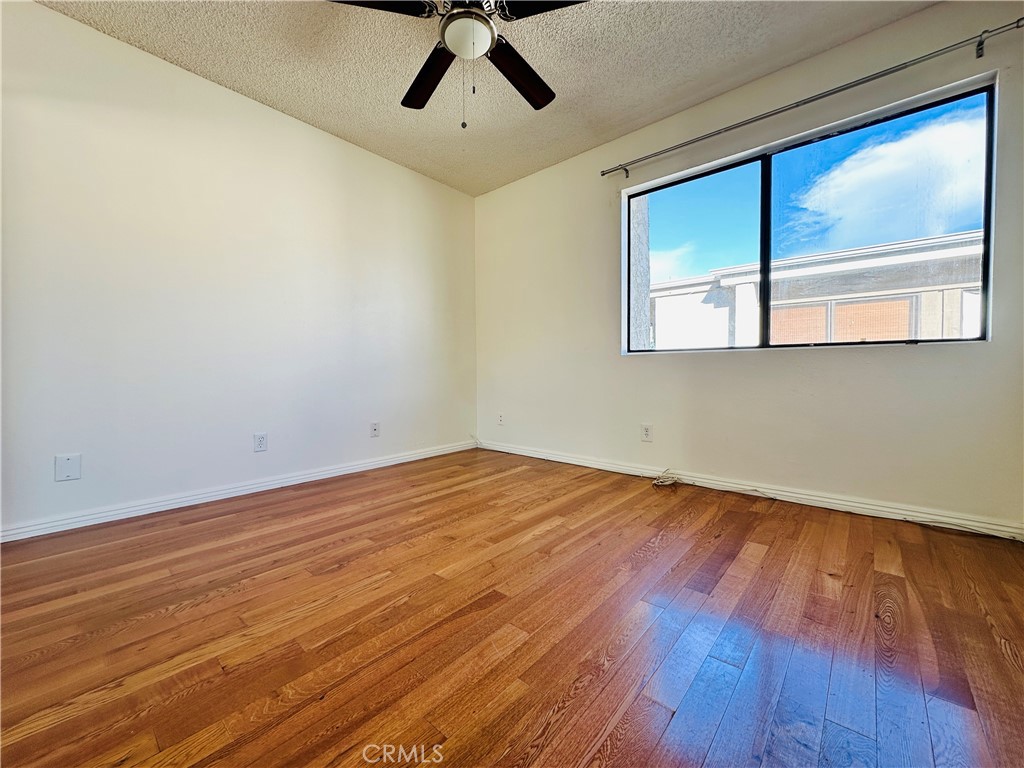 4146 Elm Avenue, Unit 5 Long Beach, CA 90807 - Photo 12 of 24 a view of empty room with wooden floor and fan