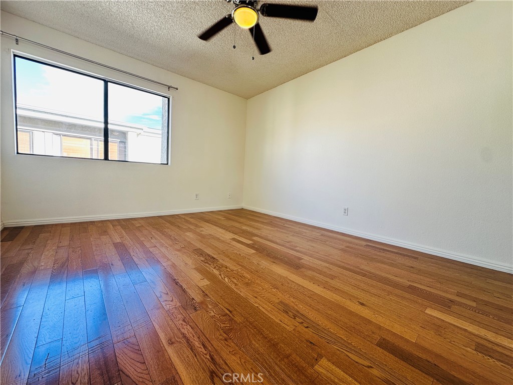 4146 Elm Avenue, Unit 5 Long Beach, CA 90807 - Photo 15 of 24 a view of empty room with wooden floor and fan