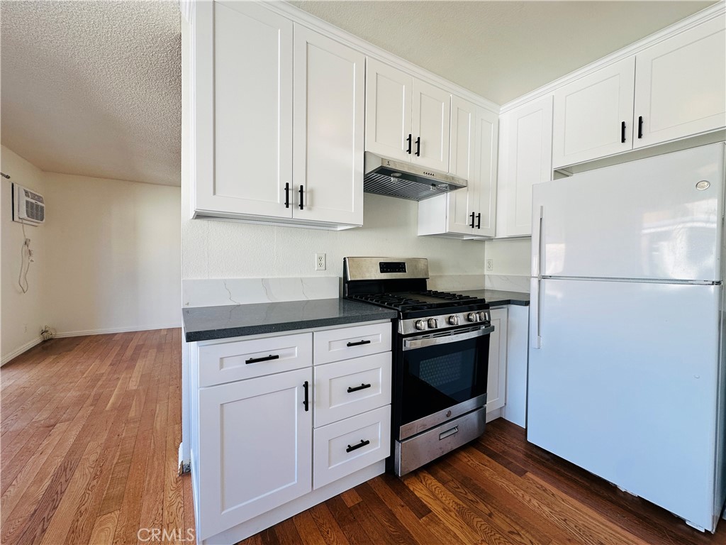 4146 Elm Avenue, Unit 5 Long Beach, CA 90807 - Photo 4 of 24 a kitchen with stainless steel appliances granite countertop a refrigerator and a stove top oven