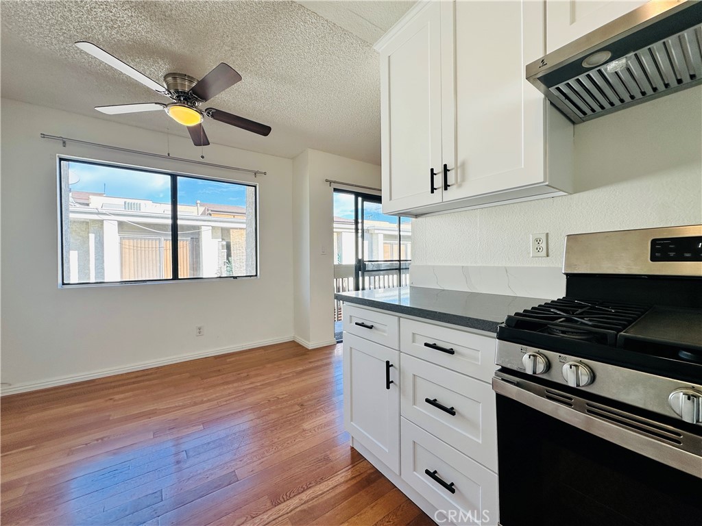 4146 Elm Avenue, Unit 5 Long Beach, CA 90807 - Photo 7 of 24 a kitchen with stainless steel appliances granite countertop a stove and a wooden floors