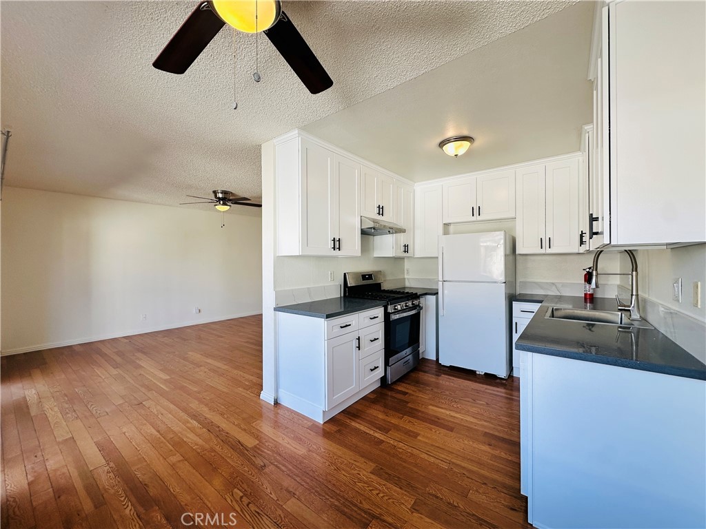 4146 Elm Avenue, Unit 5 Long Beach, CA 90807 - Photo 10 of 24 a kitchen with granite countertop a refrigerator and a sink