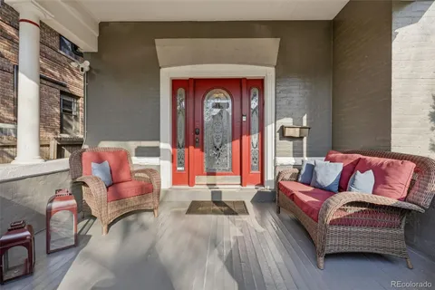 a living room with furniture and entry gate