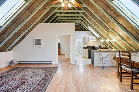 a dining room with furniture and wooden floor
